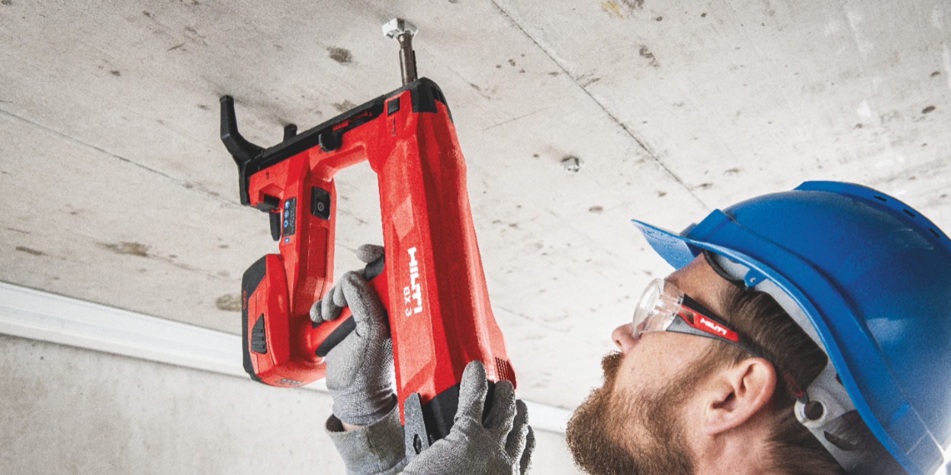 BX 3 battery-powered nailer, a low vibration alternative to drilling, being used to fasten on concrete